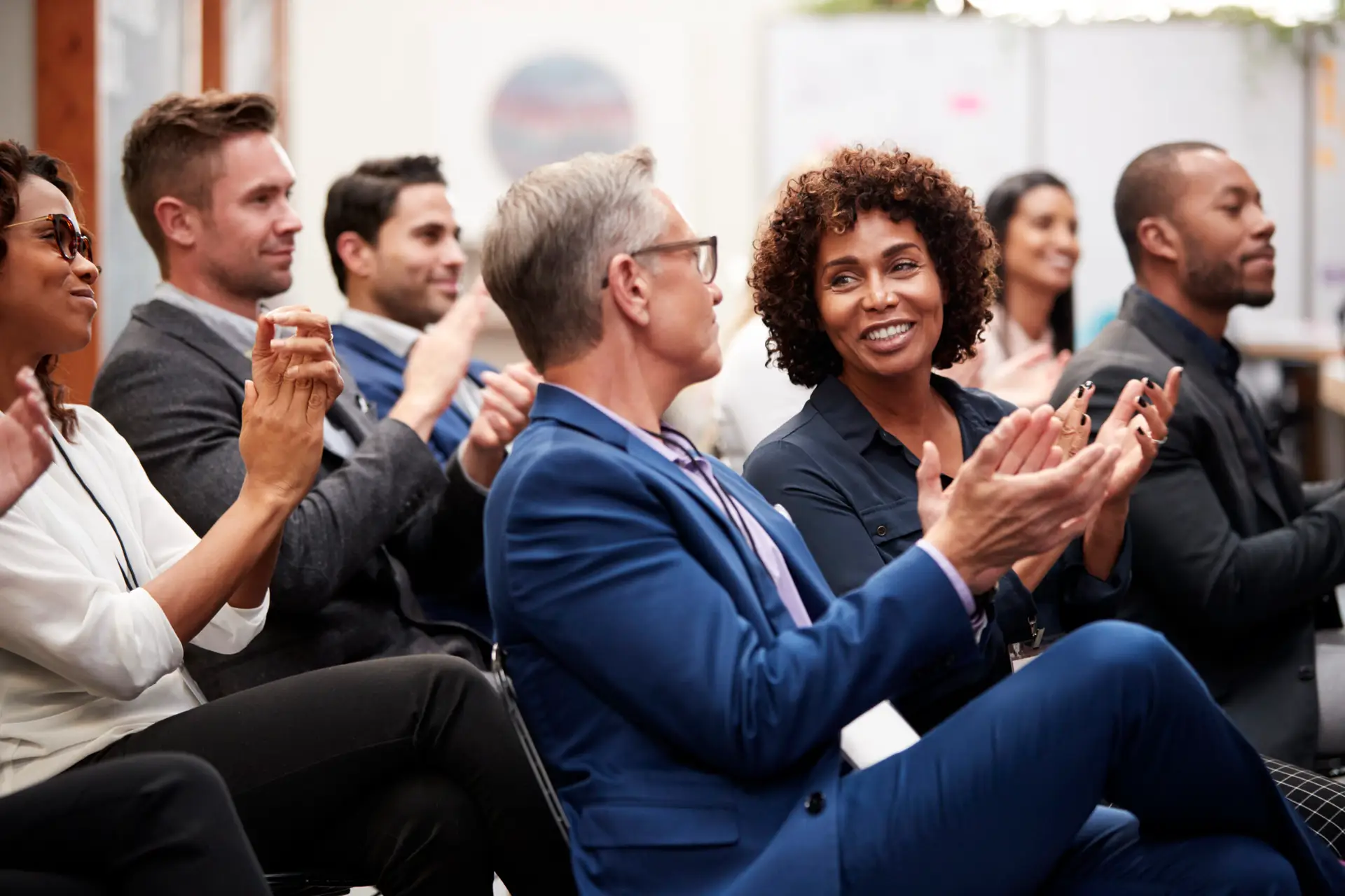 Business professionals applauding at a conference
