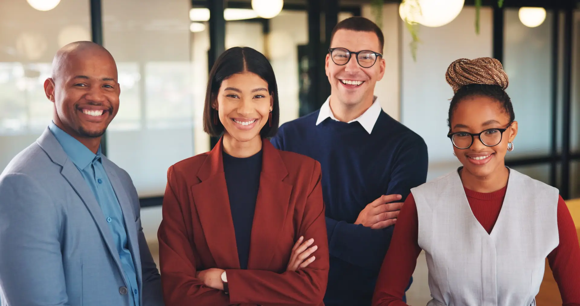 Four professionals together in a modern workplace